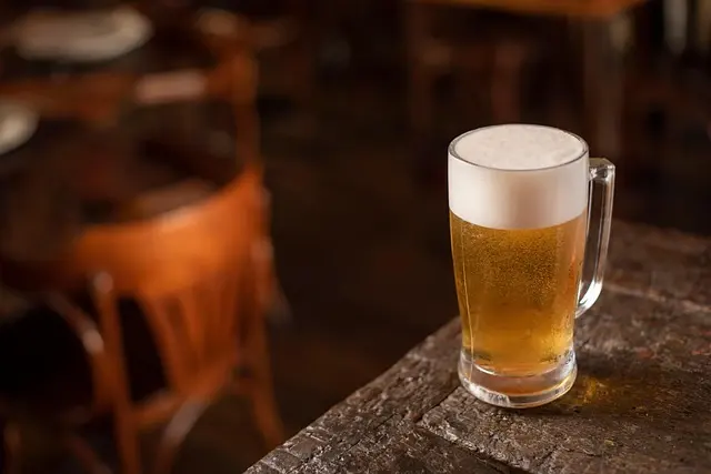 A cold beer on a bar rail at a music venue